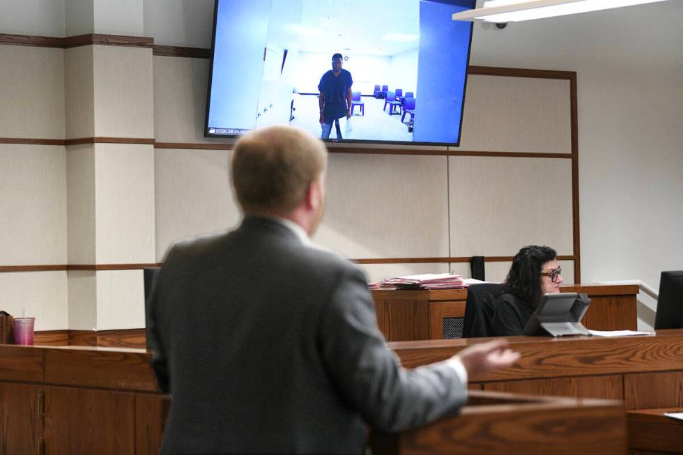 Antwone Washington appears on a monitor while public defender Tyler Gaston argues for his relea ...