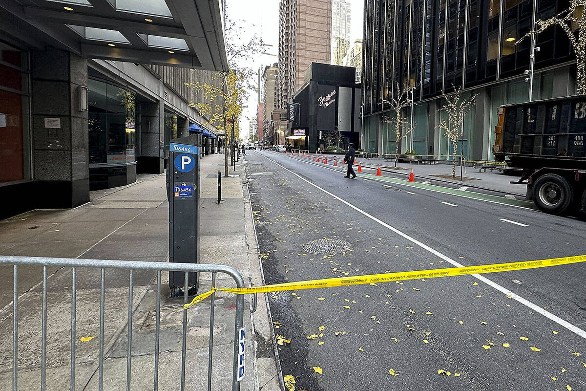 A New York police officer walks outside a hotel where a shooting occurred in midtown Manhattan, ...