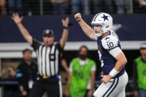 Dallas Cowboys quarterback Cooper Rush (10) celebrates after running back Rico Dowdle (23) ran ...