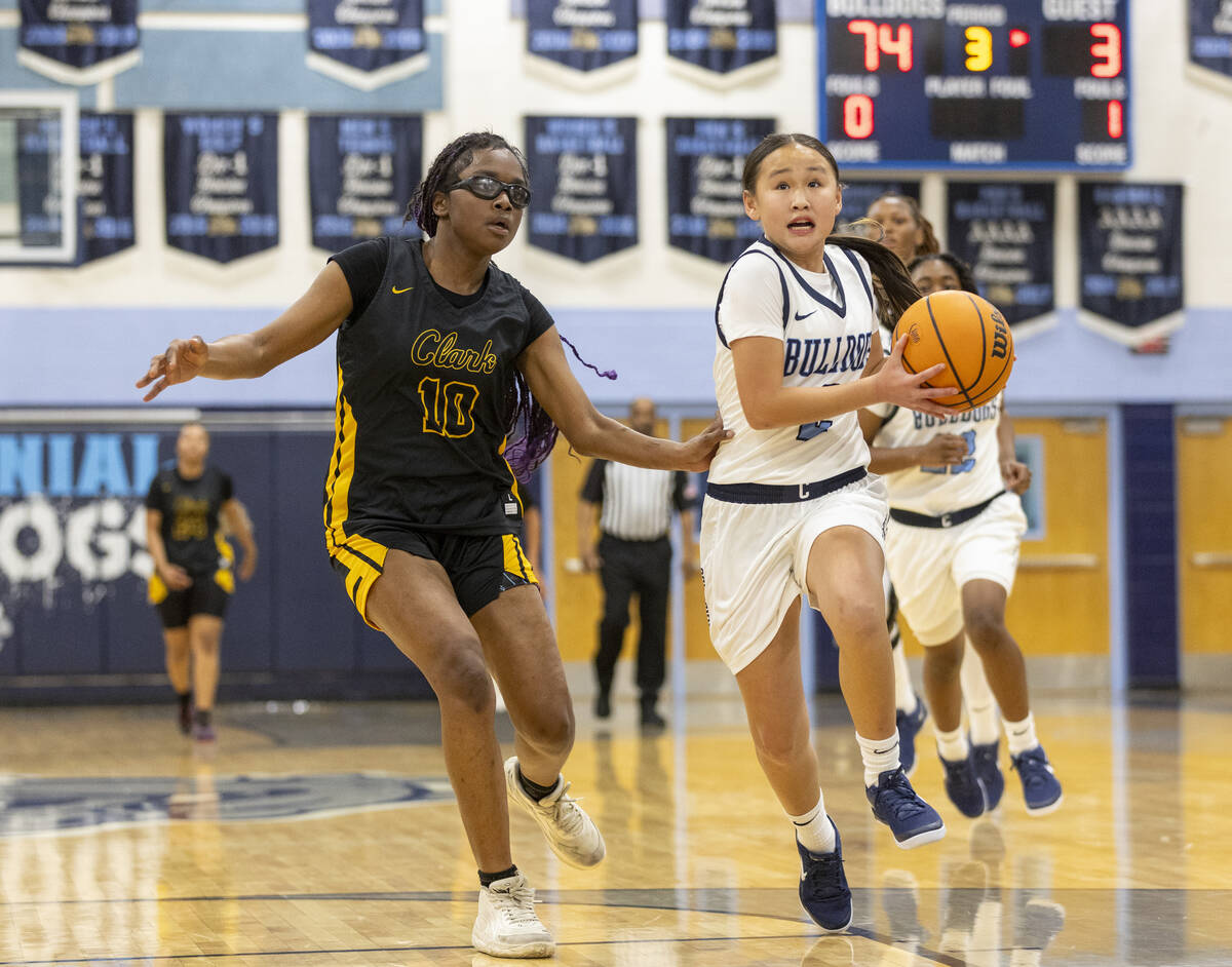 Centennial freshman Gunj Amarbold, right, rushes to the hoop during the high school girls baske ...