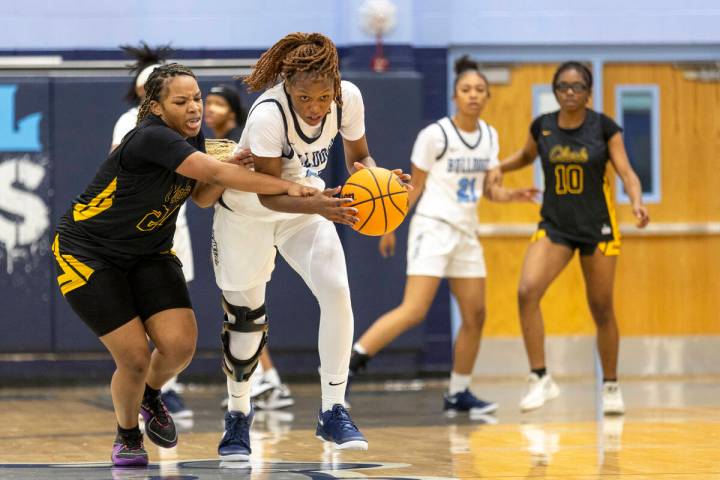 Centennial junior Inieye Oruh, right, steals the ball from Clark’s Paradise Norsworthy, left, ...