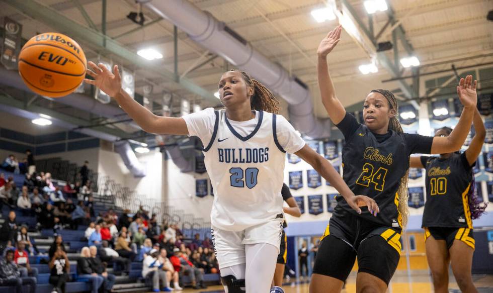 Centennial junior Inieye Oruh (20) reaches for the ball during the high school girls basketball ...