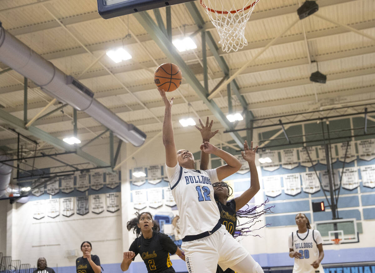 Centennial senior Ayla Williams (12) attempts a layup during the high school girls basketball g ...