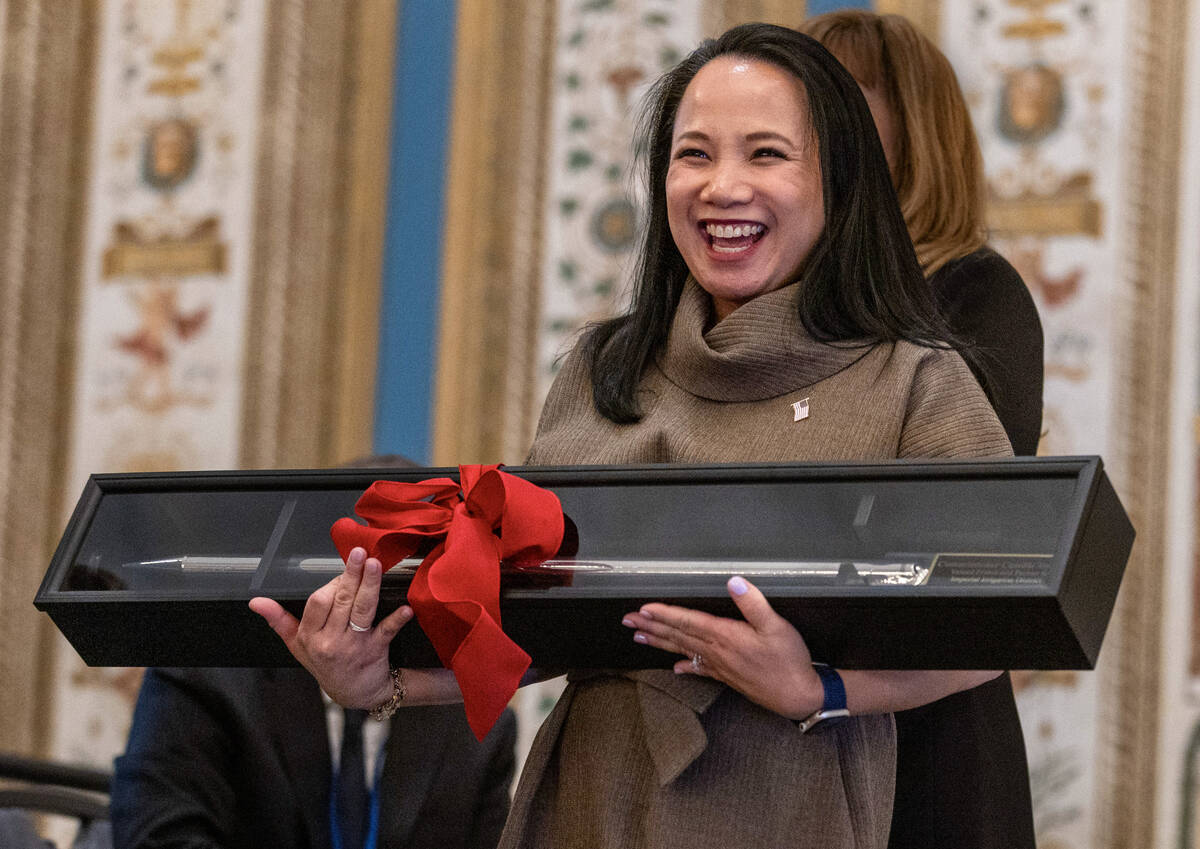 Camille Calimlim Touton, current Bureau of Reclamation commissioner, holds a gate bar as a gift ...