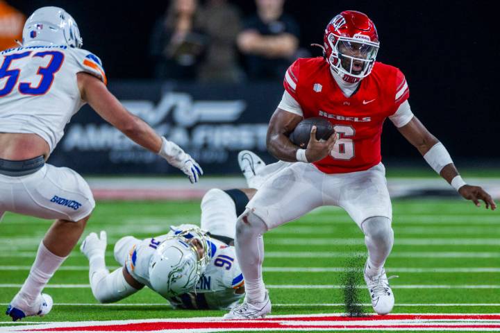 UNLV quarterback Hajj-Malik Williams (6) leaves Boise State Broncos defensive end Ahmed Hassane ...