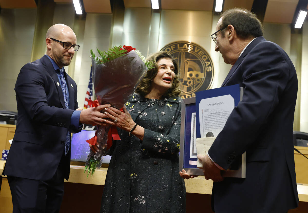 Mayor Shelley Berkley receives flowers from Councilman Brian Knudsen, left, after being sworn i ...