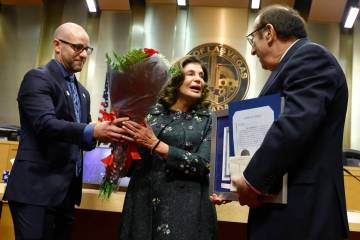 Mayor Shelley Berkley receives flowers from Councilman Brian Knudsen, left, after being sworn i ...