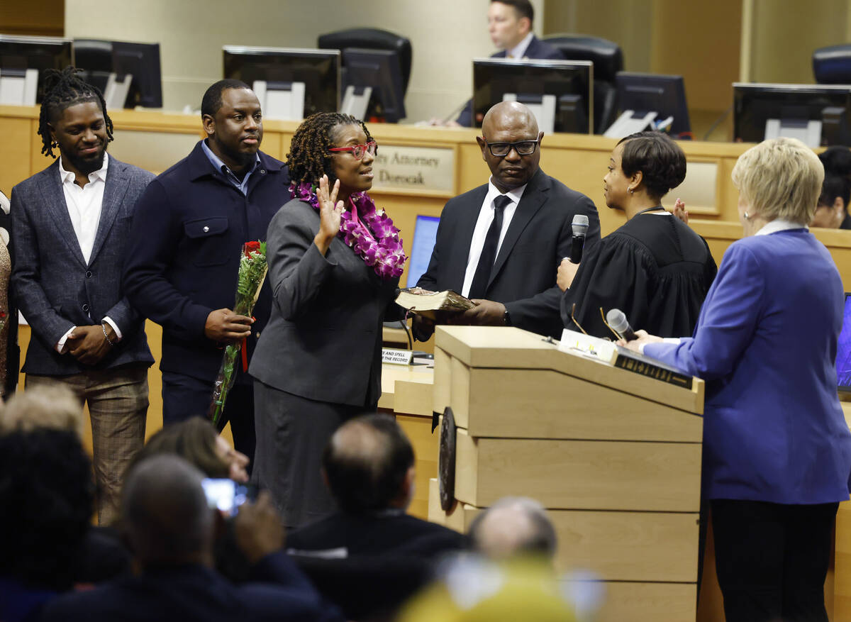 Councilwoman Shondra Summers-Armstrong, center, sworn in by District Judge Tierra Jones, second ...