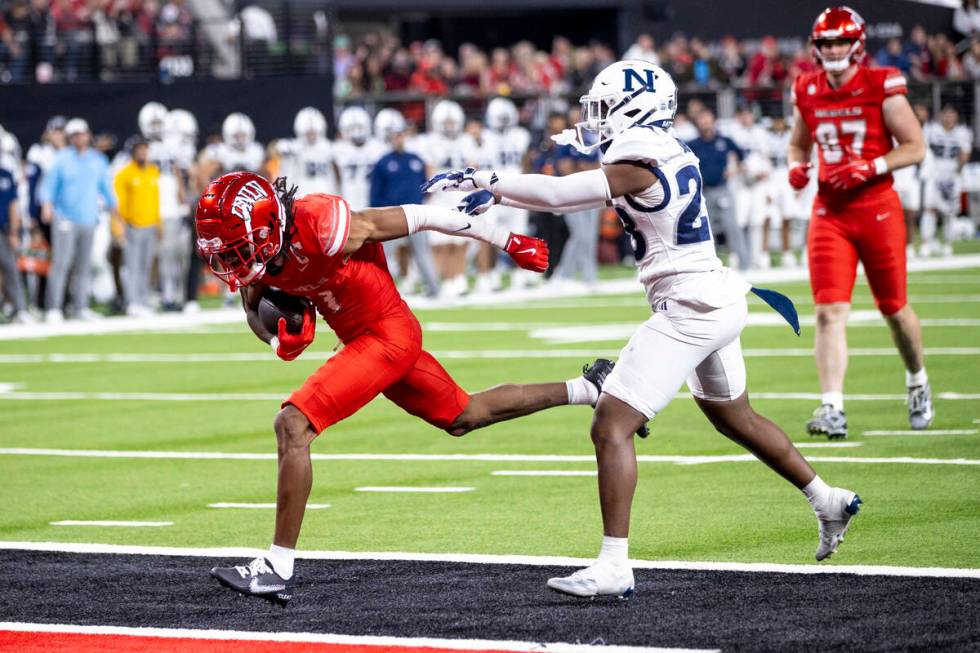 UNLV wide receiver Ricky White III, left, runs into the end zone for a touchdown during the NCA ...