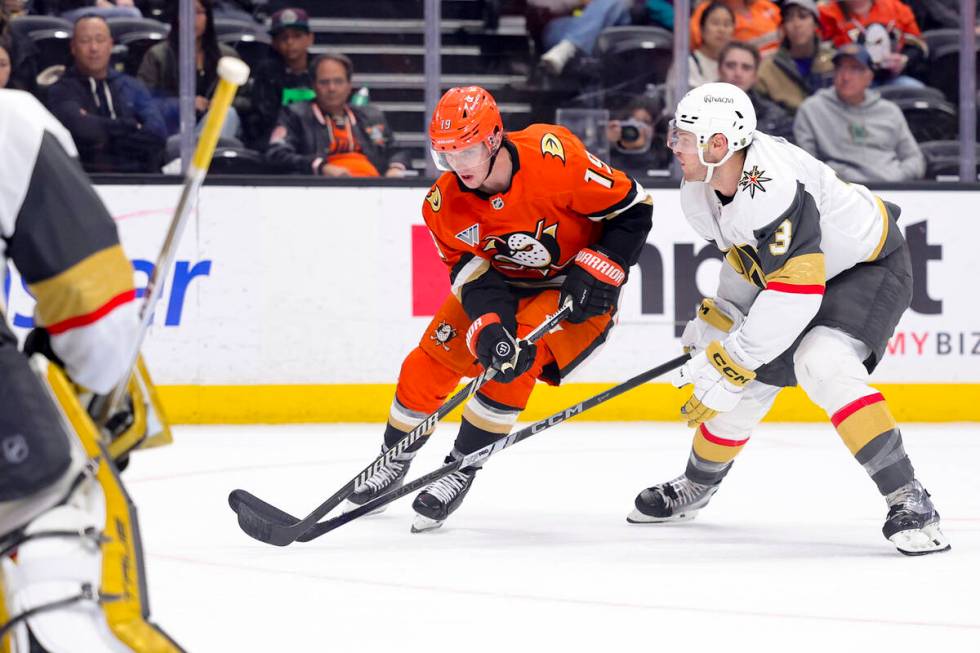 Anaheim Ducks right wing Troy Terry, left, shoots against Vegas Golden Knights defenseman Brayd ...