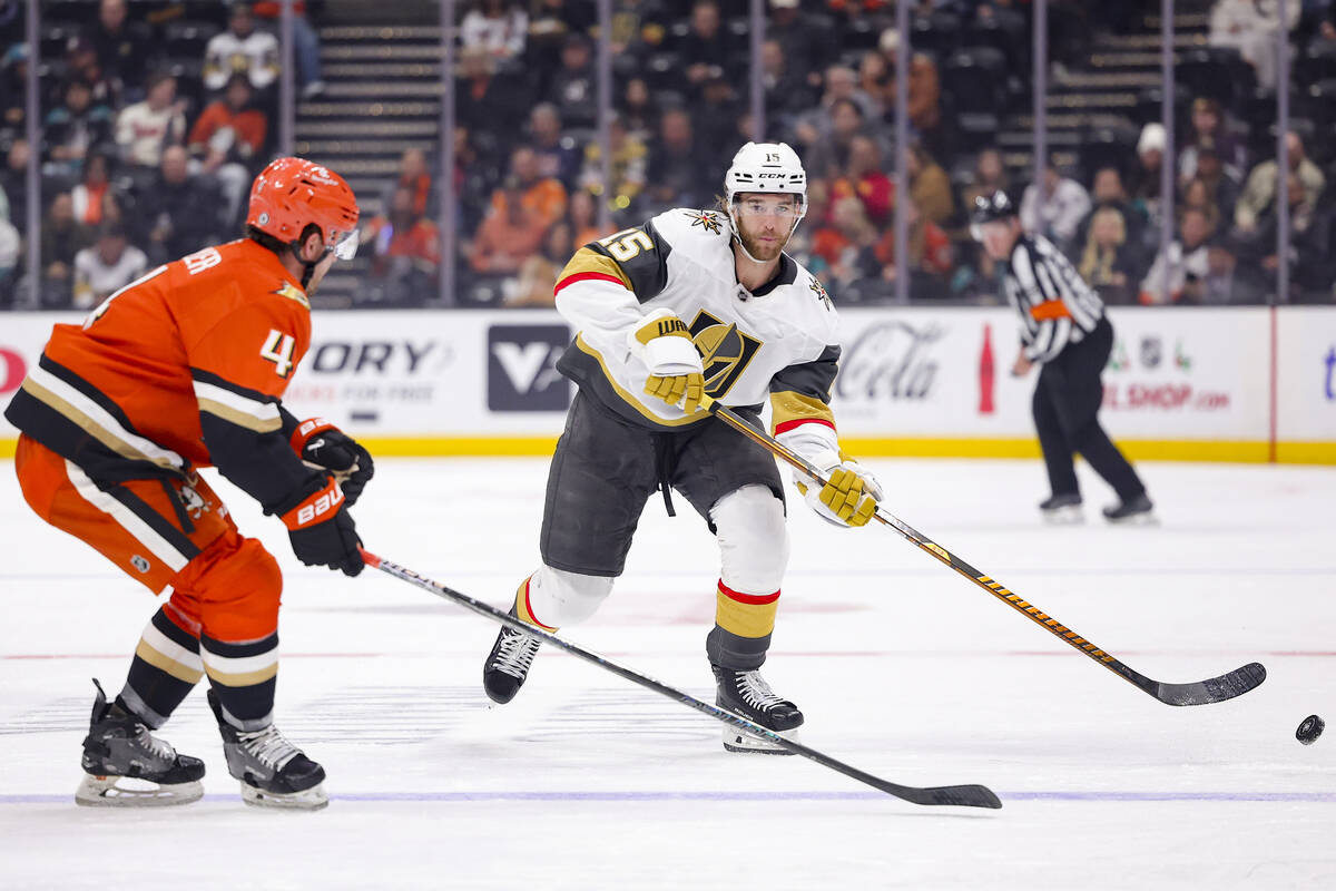 Vegas Golden Knights defenseman Noah Hanifin, right, clears the puck against Anaheim Ducks defe ...