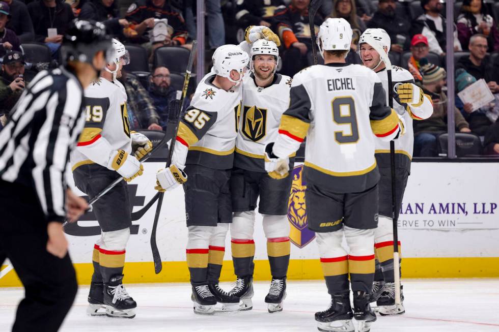 Vegas Golden Knights defenseman Shea Theodore, center, celebrates with teammates after scoring ...