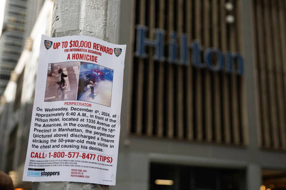 A reward poster hangs on a light pole outside the Hilton Hotel in midtown Manhattan where Brian ...