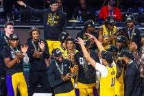 Los Angeles Lakers forward LeBron James (23) holds up his MVP trophy about teammates after defe ...