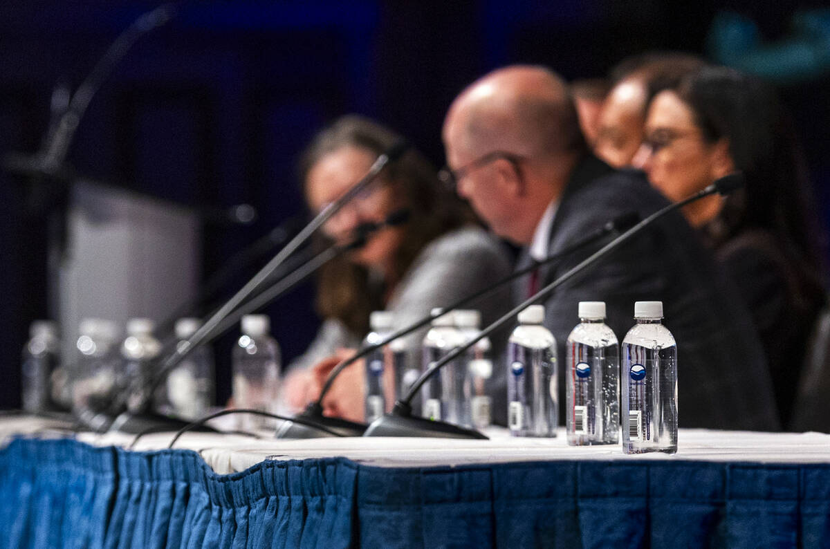 Water bottles are placed for usage by panel members as the speak during the Upper Basin Princip ...