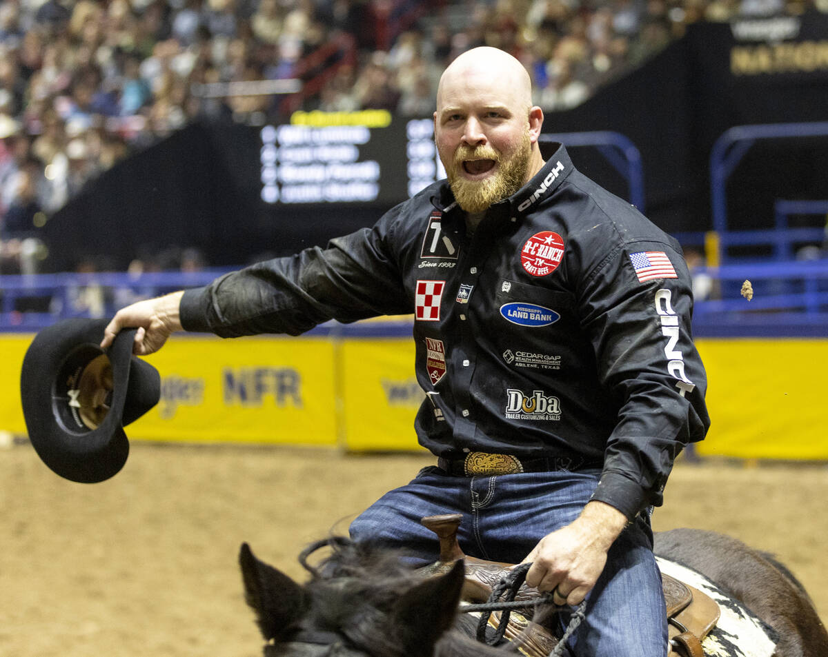 Will Lummus takes a victory lap after winning the steer wrestling event during opening night of ...