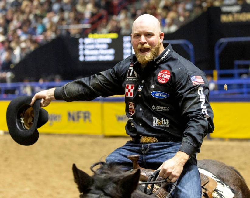 Will Lummus takes a victory lap after winning the steer wrestling event during opening night of ...