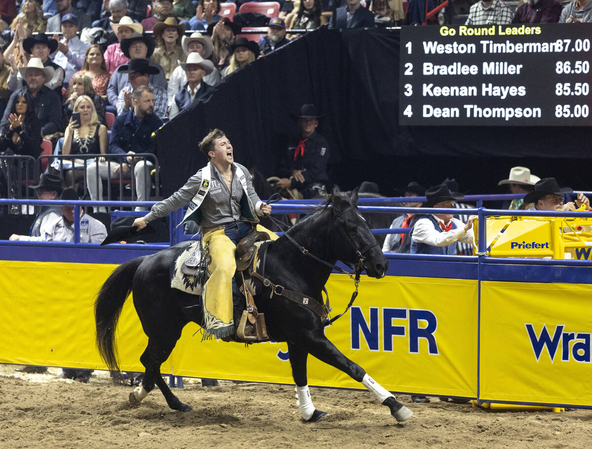 Weston Timberman takes a victory lap after winning the bareback riding event during opening nig ...