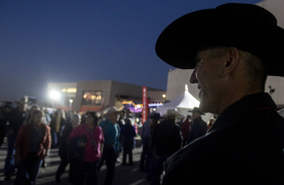 Attendees walk around before opening night of the National Finals Rodeo outside the Thomas &amp ...