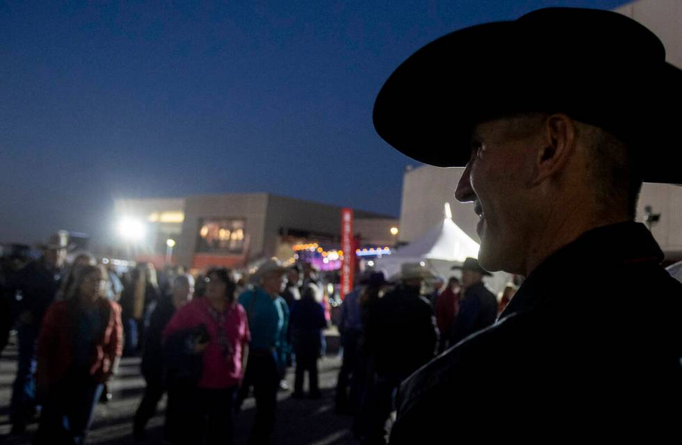 Attendees walk around before opening night of the National Finals Rodeo outside the Thomas &amp ...