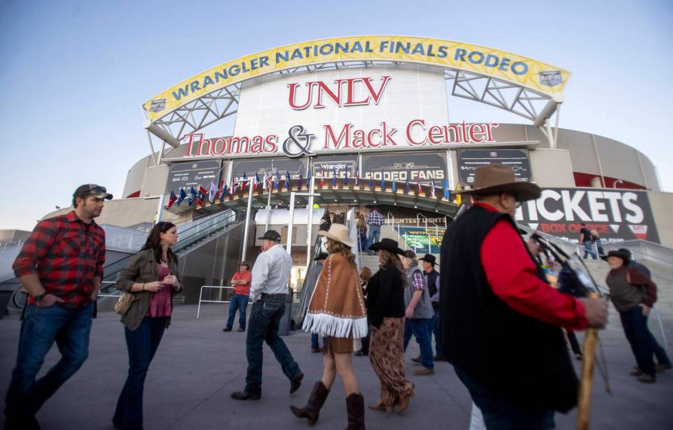 Attendees walk around before opening night of the National Finals Rodeo outside the Thomas &amp ...