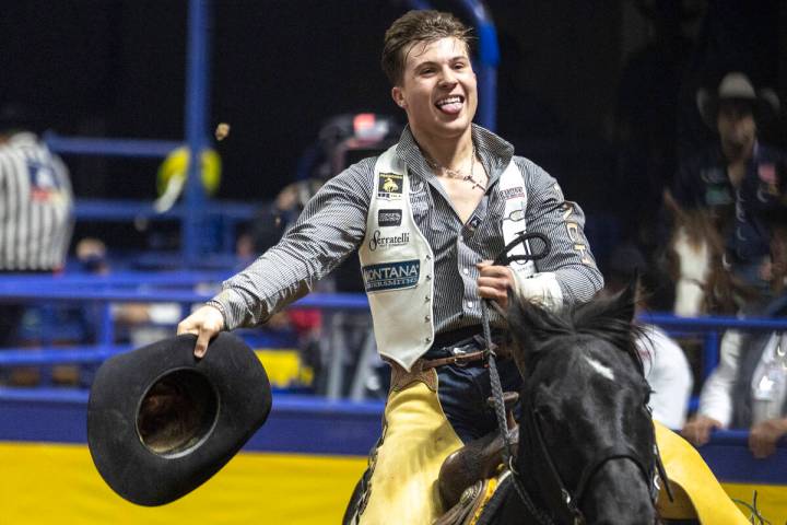 Weston Timberman takes a victory lap after winning the bareback riding event during opening nig ...