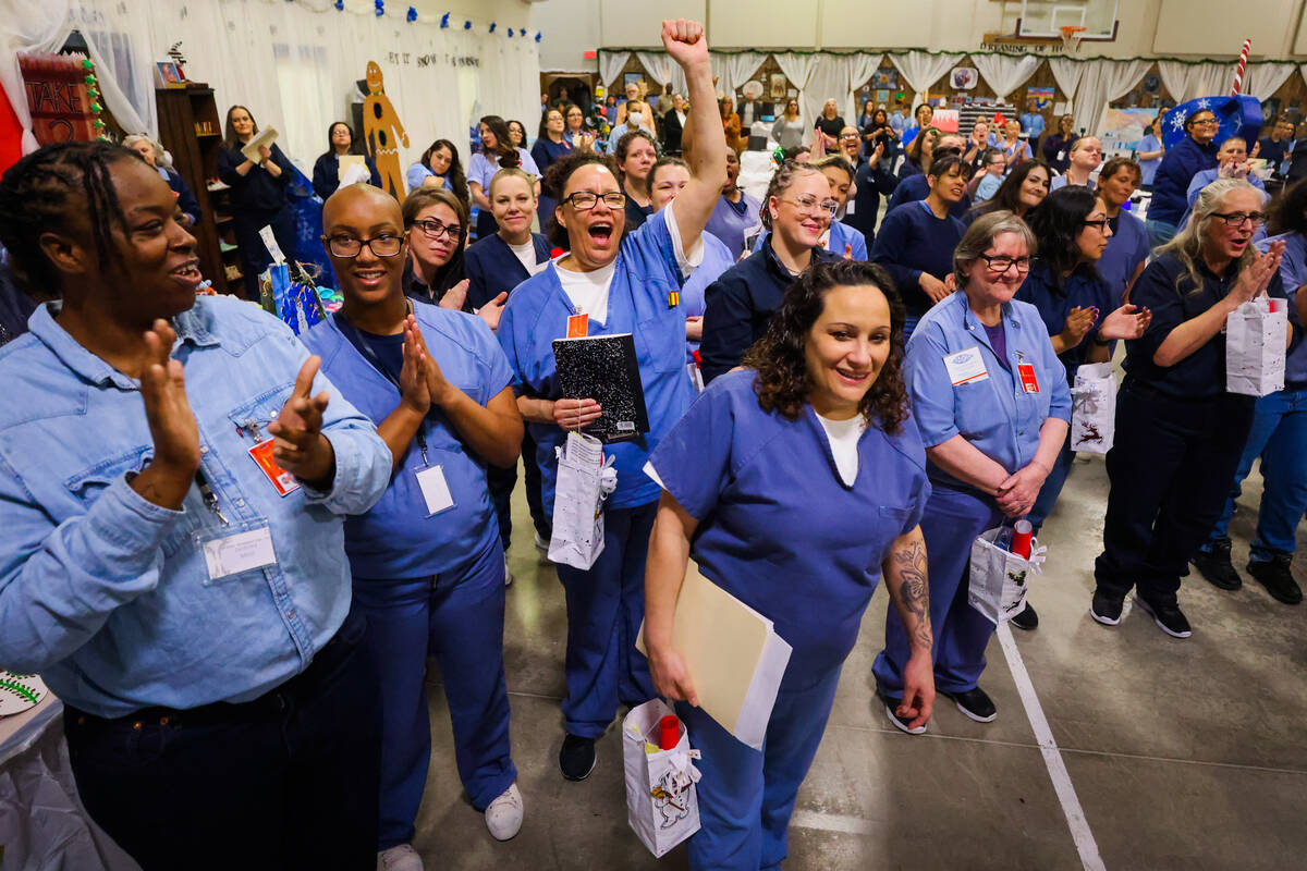 Inmates clap and cheer during an event to highlight incarcerated women who completed the touris ...