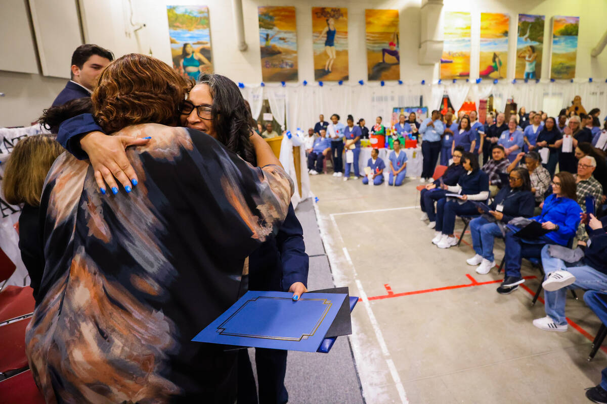 Kellie Phillips, facing, hugs Dr, Grayce James, a hospitality and tourism instructor, after rec ...