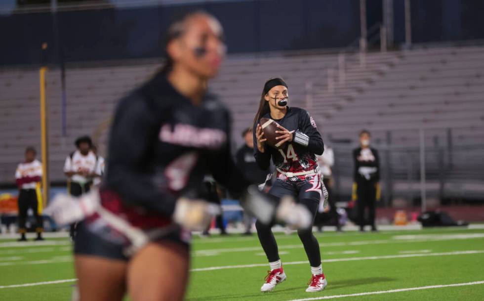 Liberty's Kaylie Phillips (14) looks to throw a pass during a flag football game against Del So ...