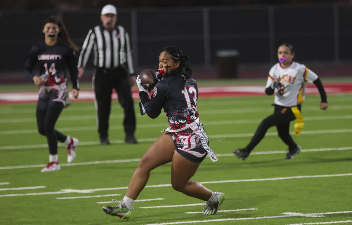 Liberty's Sheaza Lopes (13) runs the ball after catching the pass during a flag football game a ...