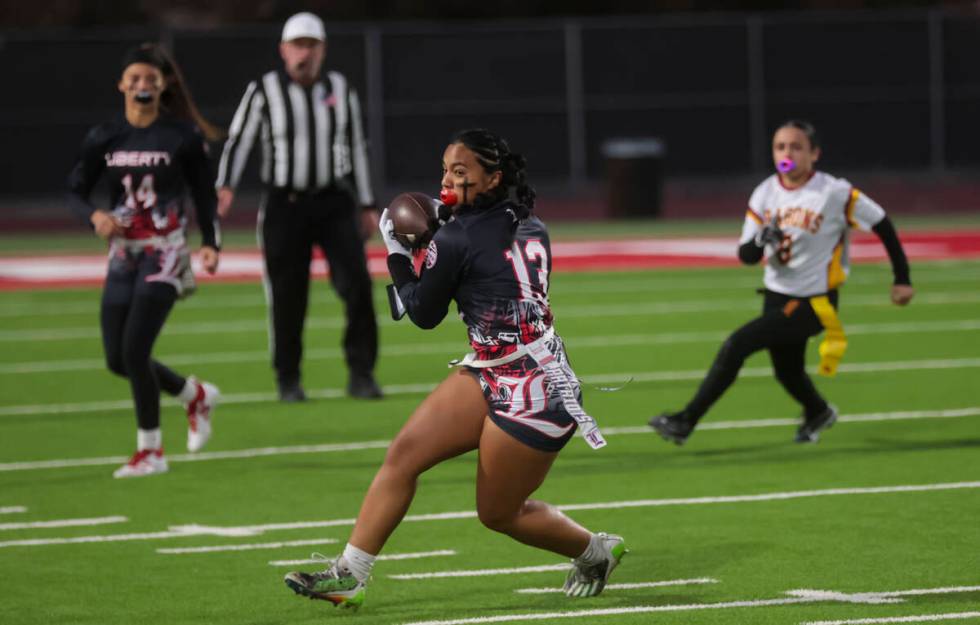 Liberty's Sheaza Lopes (13) runs the ball after catching the pass during a flag football game a ...