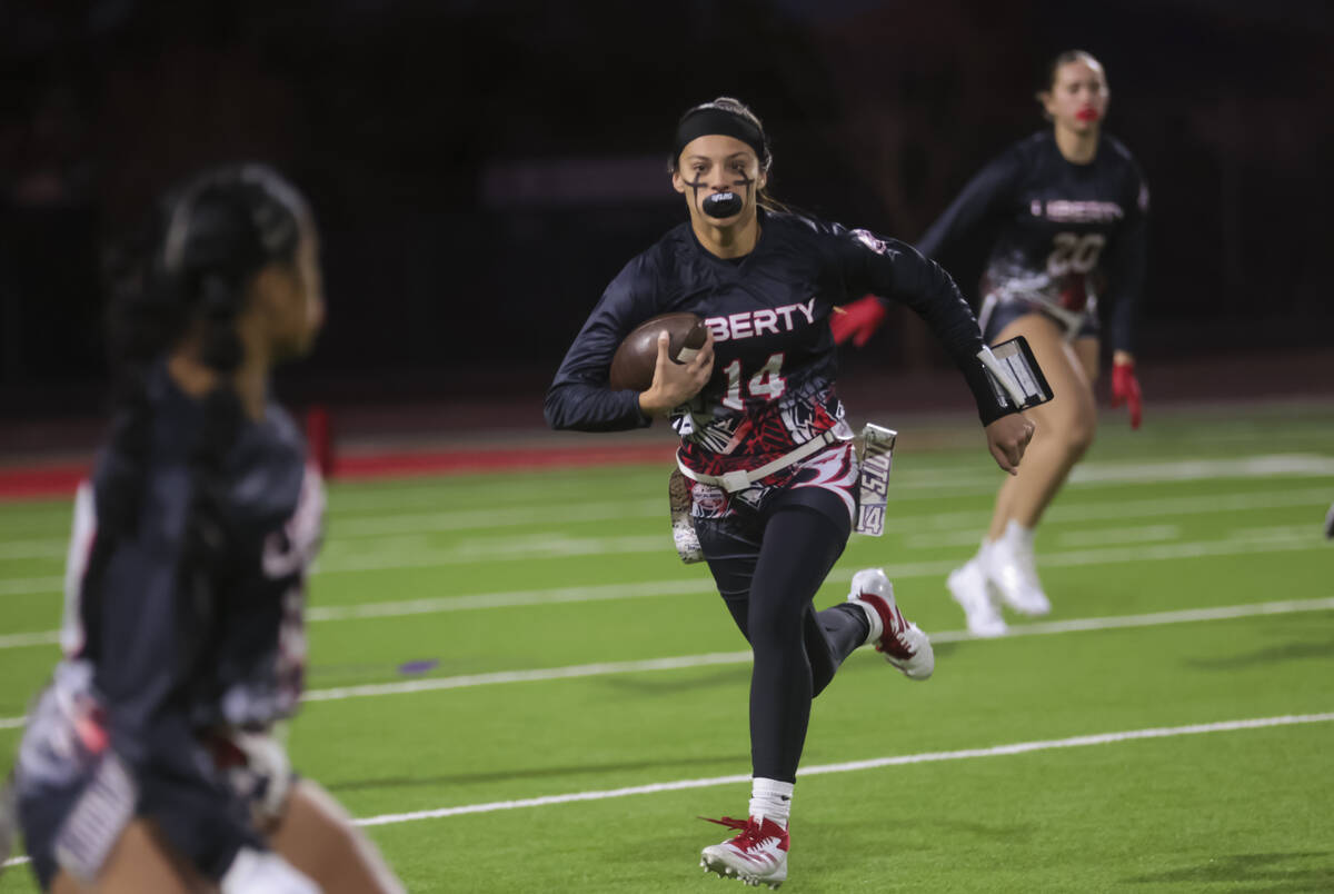 Liberty's Kaylie Phillips (14) runs the ball against Del Sol during a flag football game at Lib ...