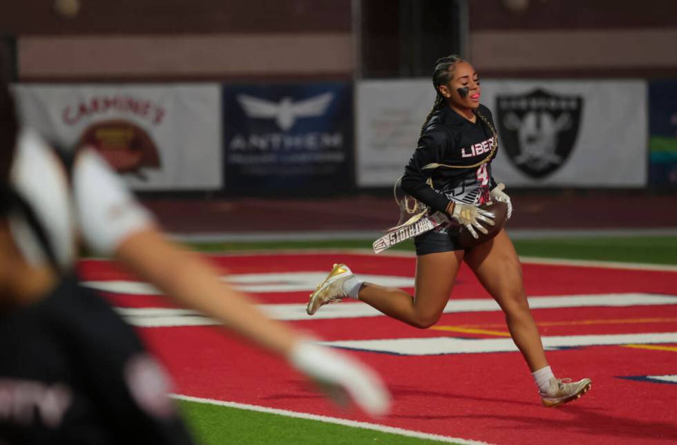 Liberty's Kilolo Westerlund (4) scores a touchdown against Del Sol during a flag football game ...