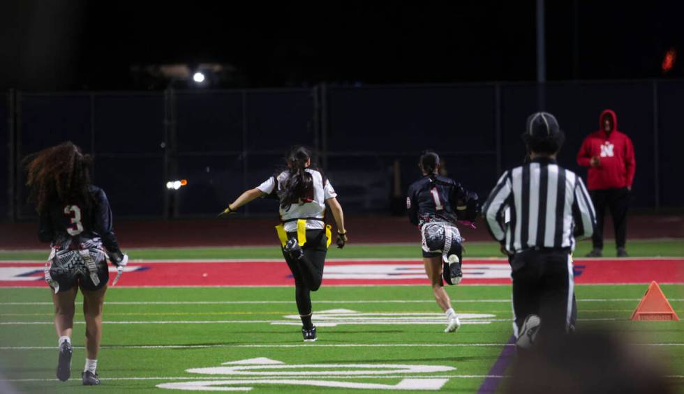 Liberty's Trishelle Tucay (1) runs the ball to score a touchdown against Del Sol during a flag ...