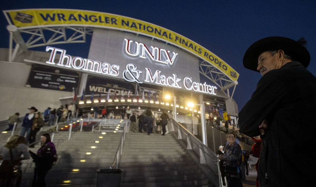 Attendees wait to enter before opening night of the National Finals Rodeo at the Thomas & M ...