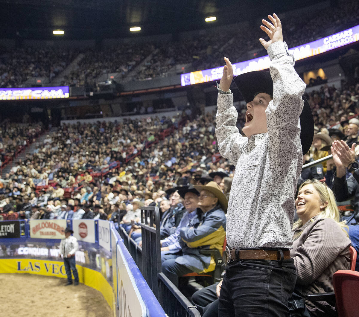 A young fan celebrates after seeing himself on the big screen during opening night of the Natio ...