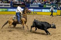 Wesley Thorp competes in the team roping event during opening night of the National Finals Rode ...