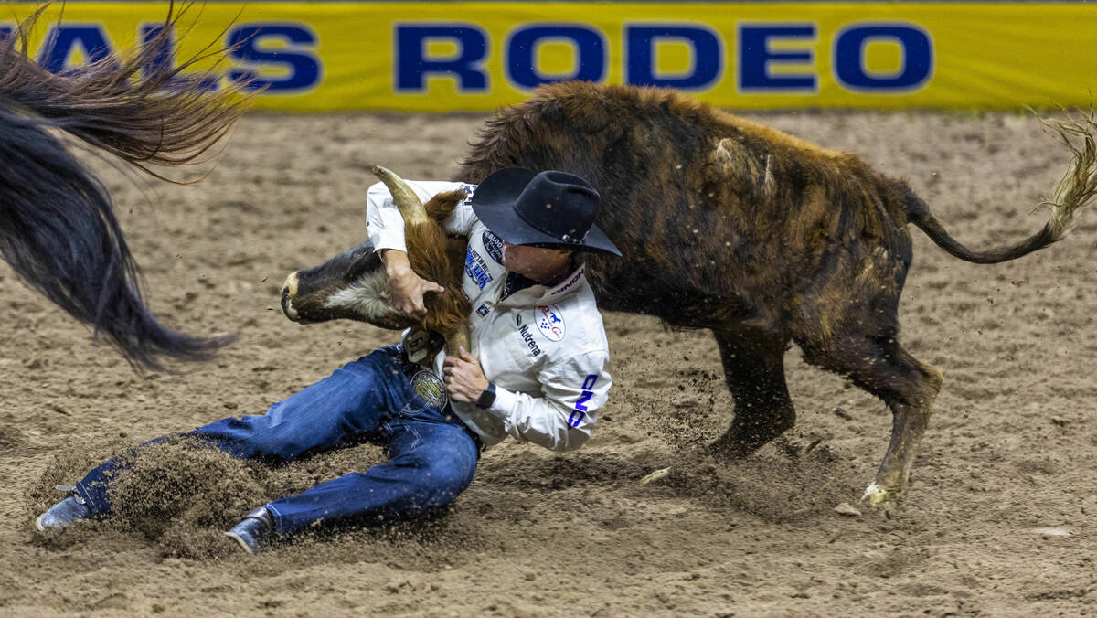 Steer wrestler Rowdy Parrott wraps up his steer for a take down during National Finals Rodeo Da ...