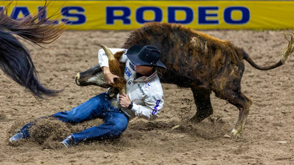 Steer wrestler Rowdy Parrott wraps up his steer for a take down during National Finals Rodeo Da ...