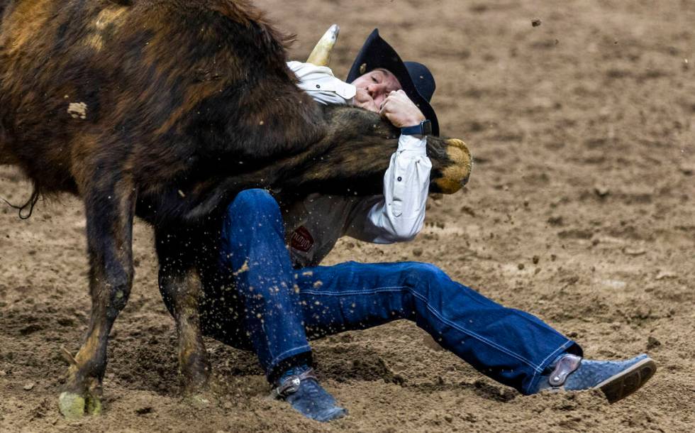 Steer wrestler Rowdy Parrott wraps up his steer for a take down during National Finals Rodeo Da ...