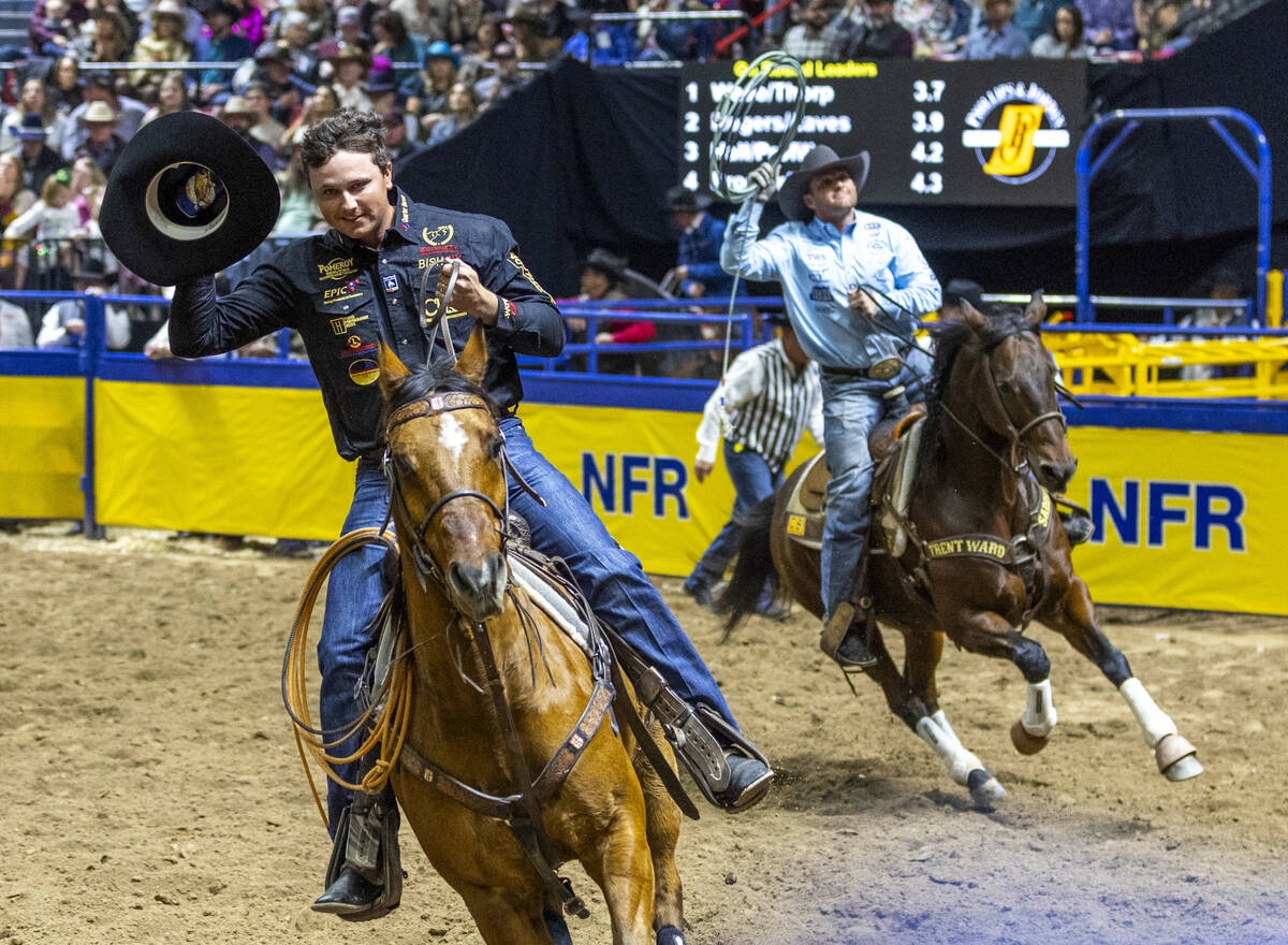 Team roping heeler Wesley Thorp, left, and header Tyler Wade take a lap after winning the event ...