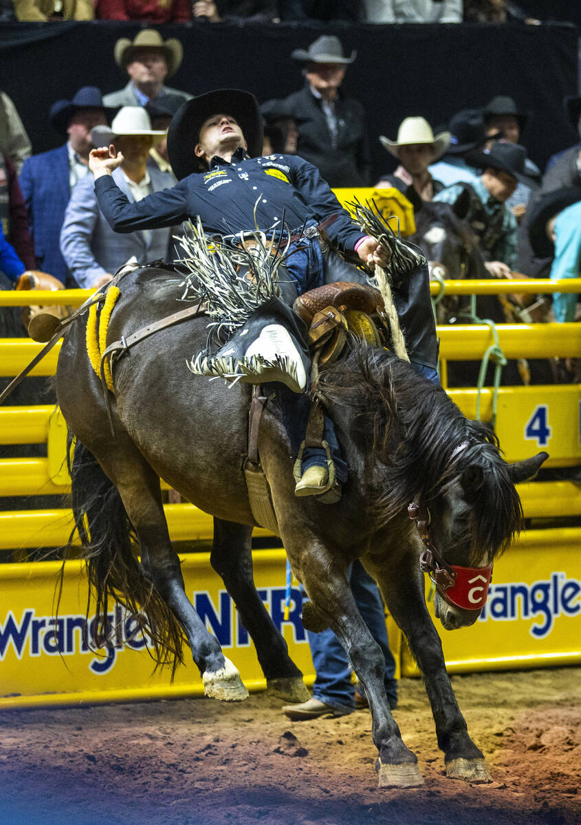 Saddle Bronc Riding competitor Brody Wells lays back on Resistol's Pretty Woman for a winning r ...