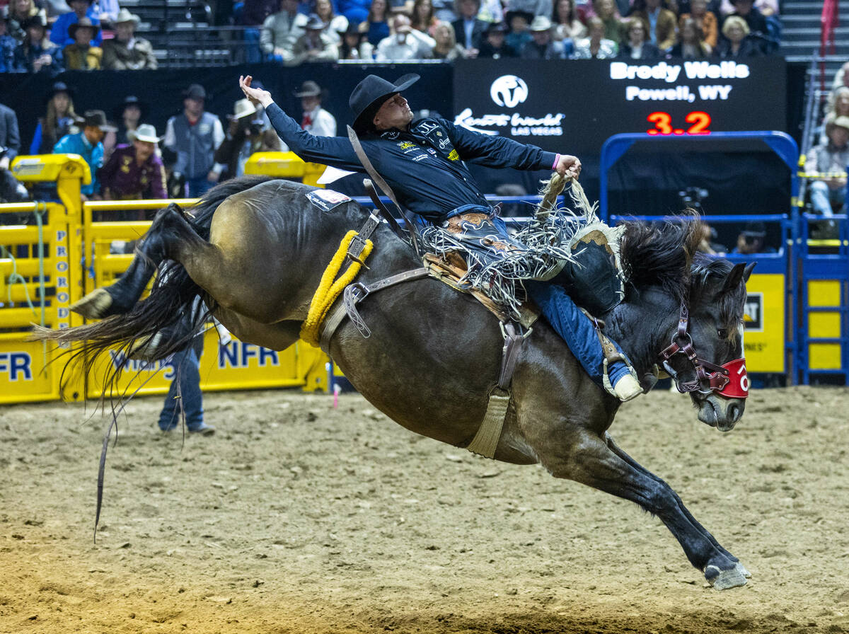 Saddle Bronc Riding competitor Brody Wells lays back on Resistol's Pretty Woman for a winning r ...