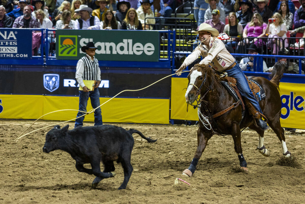 Tie-Down Roping competitor Riley Webb tosses a rope as his calf on the way to a winning time du ...