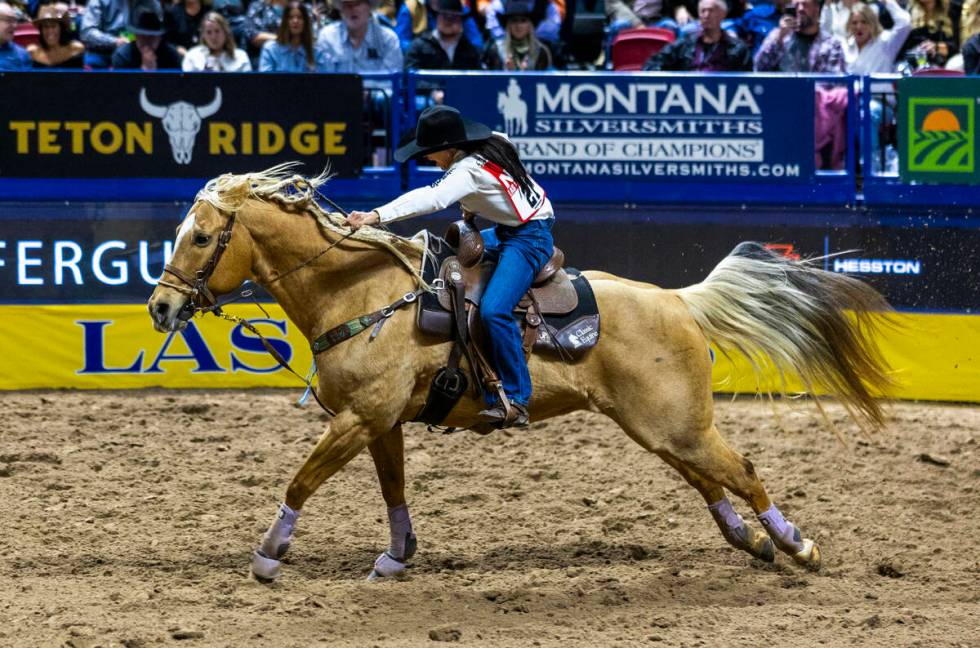 Barrel Racing competitor Hailey Kinsel heads to the fininsh on the way to a winning time during ...