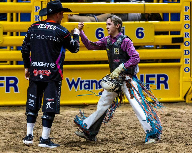 Bull Riding competitor Jeter Lawrence celebrates his winning ride with bullfighter Nate Jestes ...