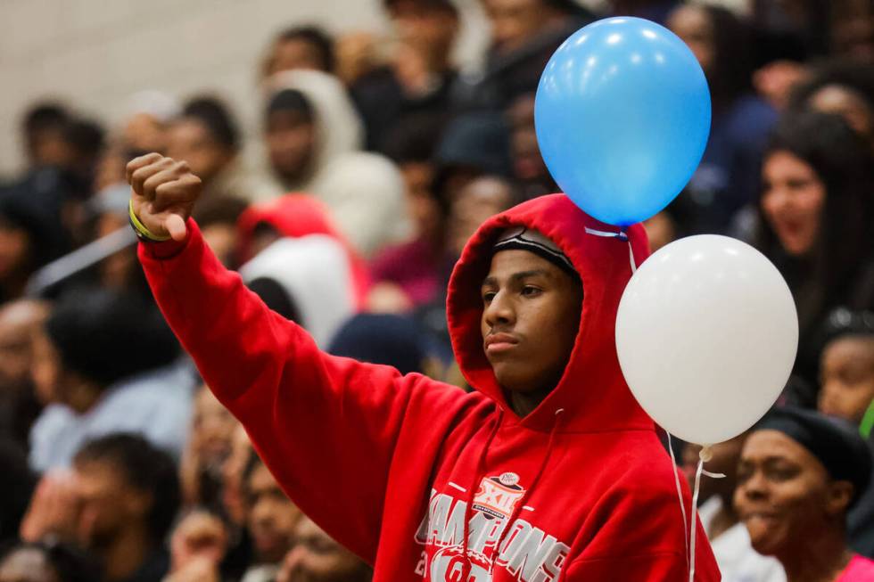 A Democracy Prep fan makes a thumbs down gesture to a referee during a boys basketball game bet ...