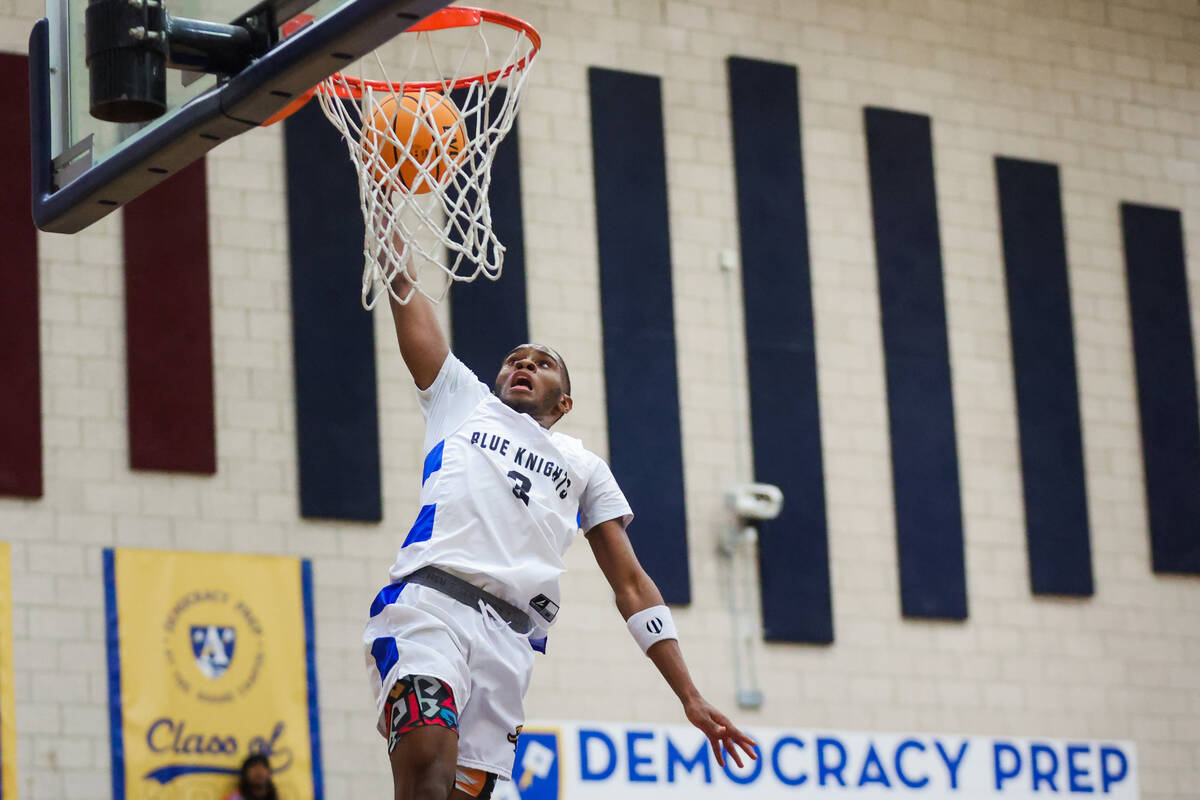 Democracy Prep guard DaShaun Harris dunks the ball into the net during a boys basketball game b ...