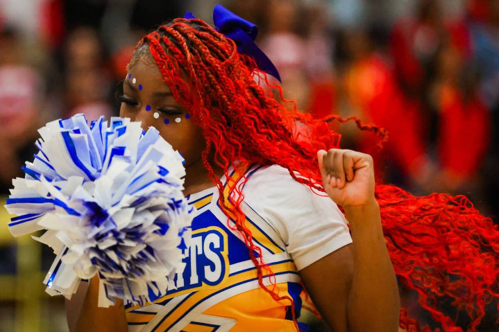 A Democracy Prep cheerleader dances during halftime at a boys basketball game between Mater Eas ...