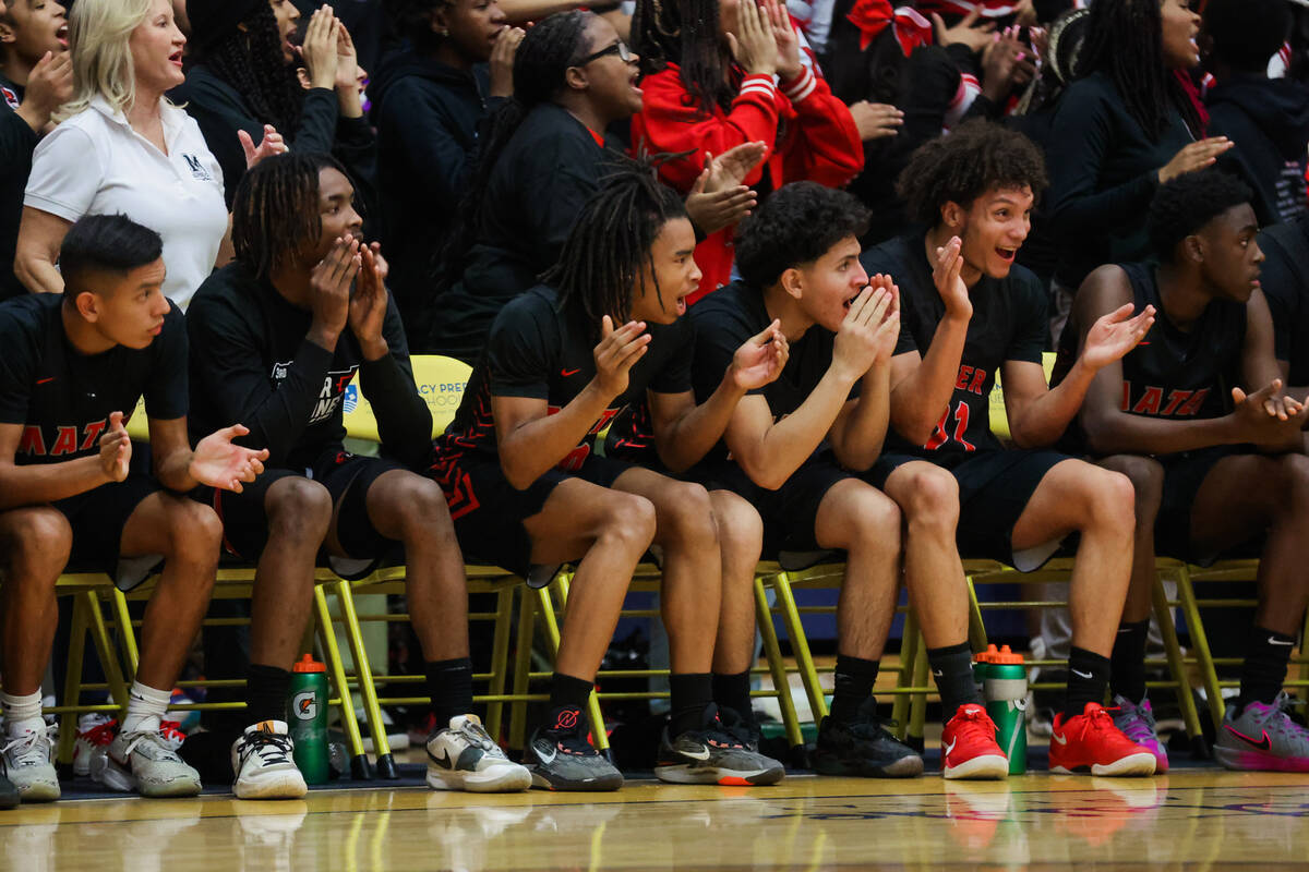 Mater players cheer for their teammates on the sidelines during a boys basketball game between ...